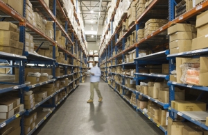 Man inspecting boxes in distribution warehouse
